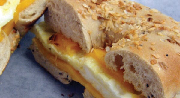 A sandwich with egg and nuts on it.