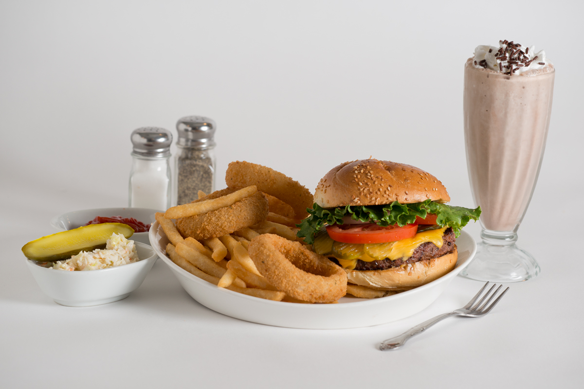 A plate of food with onion rings and hamburger.